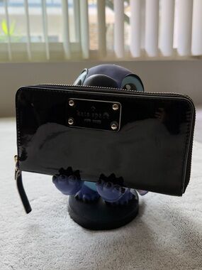 kate spade glossy black patent zip-around wallet with logo plaque